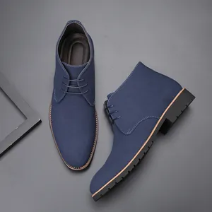 Detailed view of navy blue suede men's chukka boots with lace-up pointed toe design