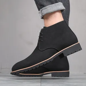 Close-up of men's black suede desert boots with lace-up detail and low heel on foot