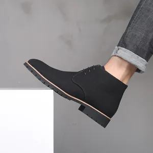 Side view of black suede lace-up desert boots for men with a low heel and pointed toe