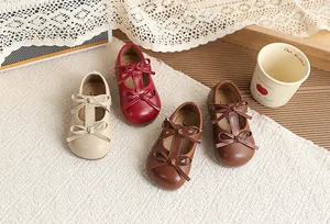 Detailed view of girl's bow Mary Jane shoes in four colors on a cozy background
