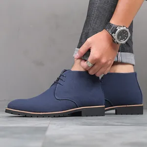 Macro view of blue suede men's chukka boots with minimalist lace-up design and durable sole