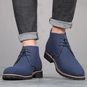 Close-up of men's blue suede lace-up chukka boots with pointed toe and low heel