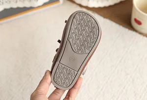 Macro shot of children's shoe sole with anti-slip carrot pattern and size 23 marking.