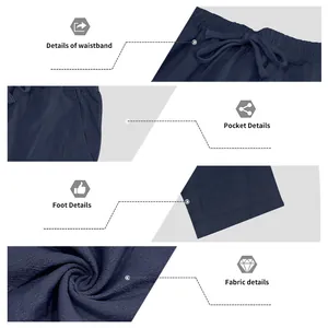 Close-up details of navy blue linen pants showing waistband, pocket, and fabric texture