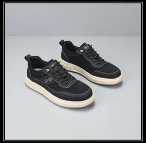 Detailed close-up of men's black thick-sole fashion sneakers with gold sport accents.