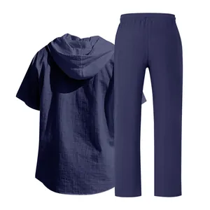 Back view of men's loose linen hooded shirt and pants set in navy blue breathable fabric