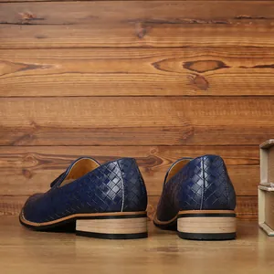 Detailed rear view of men's blue woven loafers showing textured finish and low heel