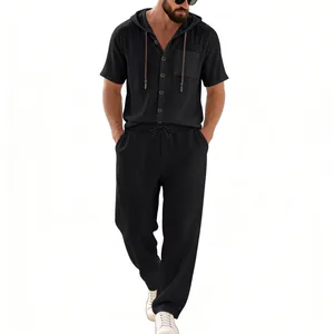 Detail of men's loose black linen hooded shirt and breathable trousers set