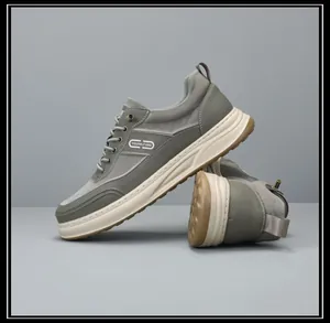 Close-up detail of grey chunky men's sneakers with soft breathable sole.