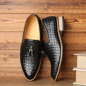 Macro detail of black woven leather loafers for men featuring elegant double tassels and leather lining