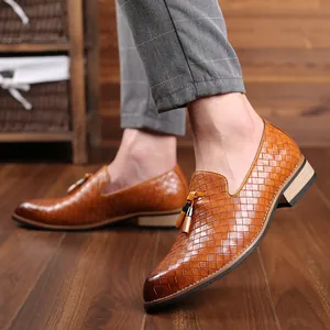 Macro view of men's woven brown loafers with tassel detail and slip-on design
