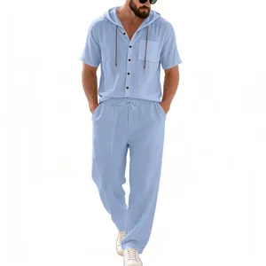 Detail of men's blue linen hooded short-sleeved shirt and matching long pants set