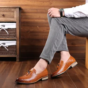 Detailed close-up of men's brown woven leather loafers with elegant tassel accents