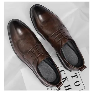 Gros plan détaillé des chaussures de ville en cuir perforé marron au fini poli