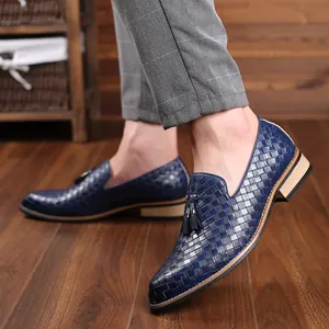 Close-up detail shot showing the intricate blue woven texture of men's tassel loafers