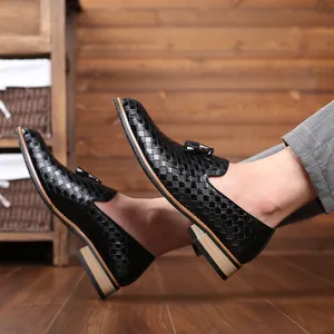 Detailed shot of black woven men's loafers featuring a unique wood grain heel design