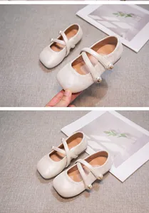 Detail of white Hanfu-style shoes for girls with elegant pearl decor and cross straps.