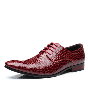Detail of men's burgundy formal dress shoes with crocodile embossed patent leather