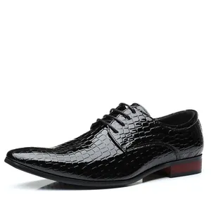 Detail shot of men's black crocodile pattern leather dress shoes with lace-up design