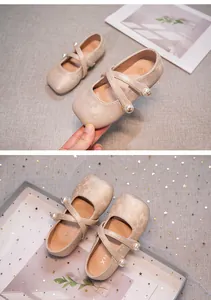 Detail of girls Hanfu shoes featuring elegant floral texture and pearl straps
