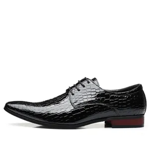 Close-up profile of black patent leather derby shoe with embossed crocodile pattern