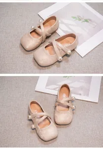 Detail of beige Hanfu shoes with floral embroidery and pearl-beaded cross straps.