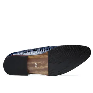 Close-up detail of the wood-texture sole and glossy stone-patterned blue men's dress shoe