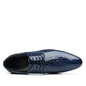 Detail top view of a stylish blue embossed stone pattern patent leather shoe for men.