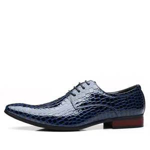 Detailed side view of navy blue men's pointed-toe dress shoes with alligator texture
