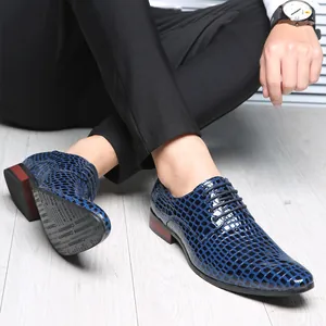 Detailed view of glossy blue stone pattern texture on men's pointed-toe dress shoes