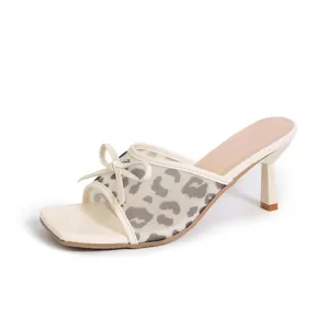Elegant leopard print mesh kitten heel mules with bow knot and square toe detail.