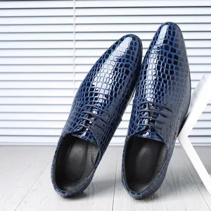Close-up of blue stone pattern embossed patent leather on men's pointed-toe dress shoes.