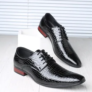Detailed view of glossy stone texture and pointed toe on men's formal leather shoes