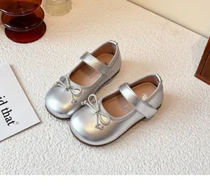 Detailed top view of silver girls' Mary Jane princess shoes with elegant bow accent