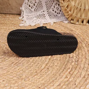 Macro detail of the anti-slip wavy rubber sole on a retro black Birkenstock style clog mule.