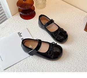 Elegant black patent leather Mary Jane shoes for girls with decorative bow detail