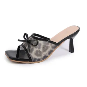 Side view of leopard print mesh high heel mule with a delicate black bow detail.