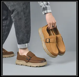 Men's leather loafers detail showing brown and tan color options worn and held in hand