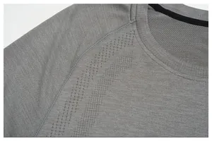 Close-up detail of grey seamless sports T-shirt showing breathable laser-cut holes.