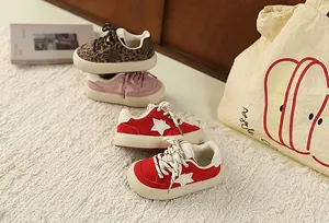 Selection of children's vintage star sneakers with thick white soles on a cozy rug