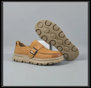 Detailed view of men's brown leather loafers with textured non-slip rubber soles