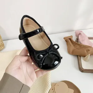 Elegant black patent leather girl's Mary Jane princess shoes with bow and soft sole