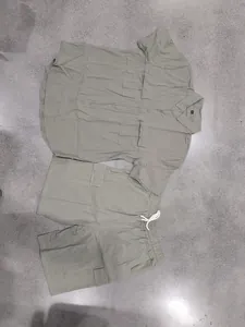 Detail view of men's olive linen cargo shirt and matching drawstring shorts set