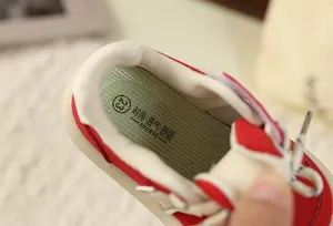Close-up of breathable insole inside a red and white retro children's sneaker