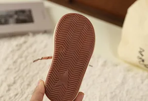 Detail view of retro kids sneaker sole with star pattern and zig-zag grip