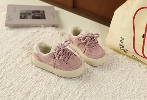 Pink suede kids' sneakers with star detail and thick soles for a retro casual look
