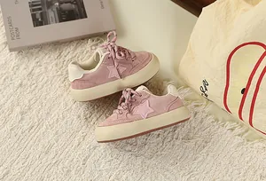 Close-up of pink children's vintage sneakers with star pattern and thick sole