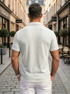 Back view of a white textured jacquard polo shirt featuring intricate woven patterns
