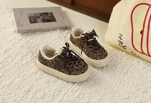 Close-up view of retro leopard print children sneakers featuring a star patch and thick sole