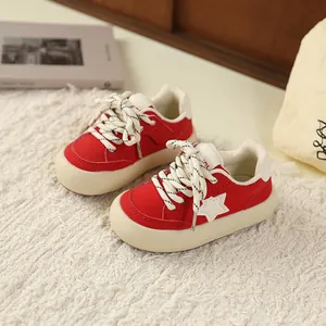 Red retro children's sneakers featuring a white star pattern and thick cream soles
